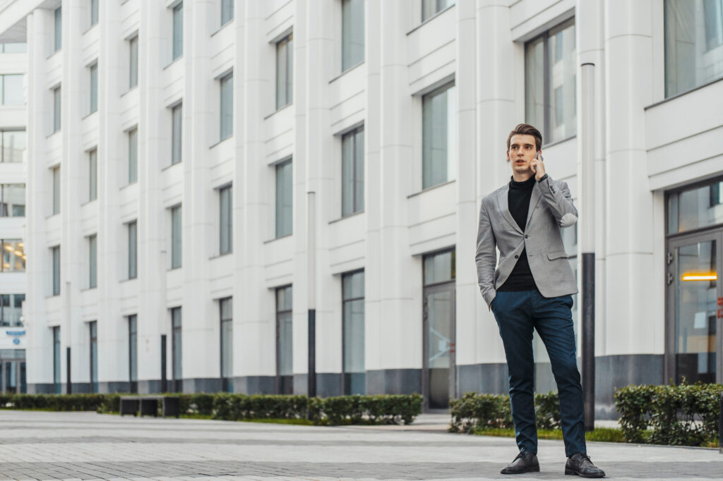 man on phone in front of building