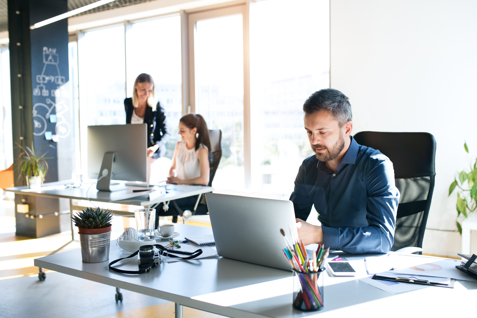 people working at desks in office