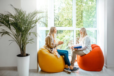 two women chatting on bean bags