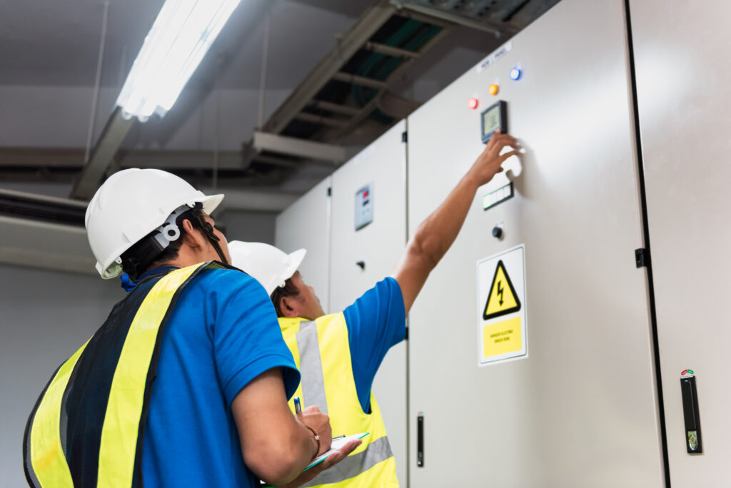 engineers working on HVAC with hard hats