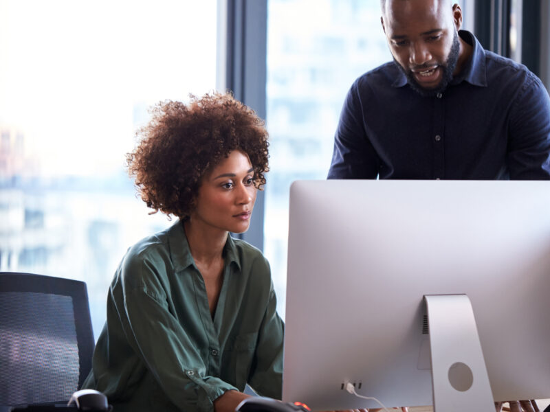 two people working on computer