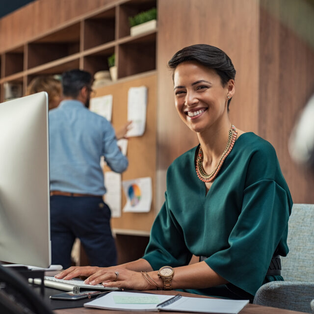 woman working at computer smiling