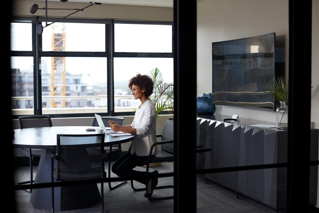 woman working alone in conference room
