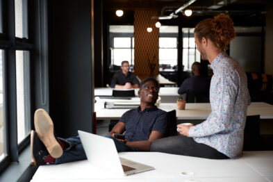 two men chatting at office desk