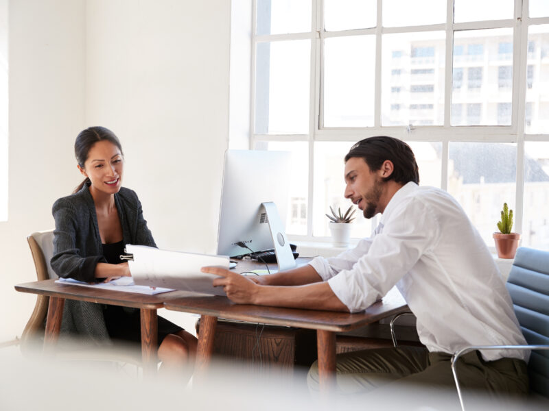 two people working together at desk