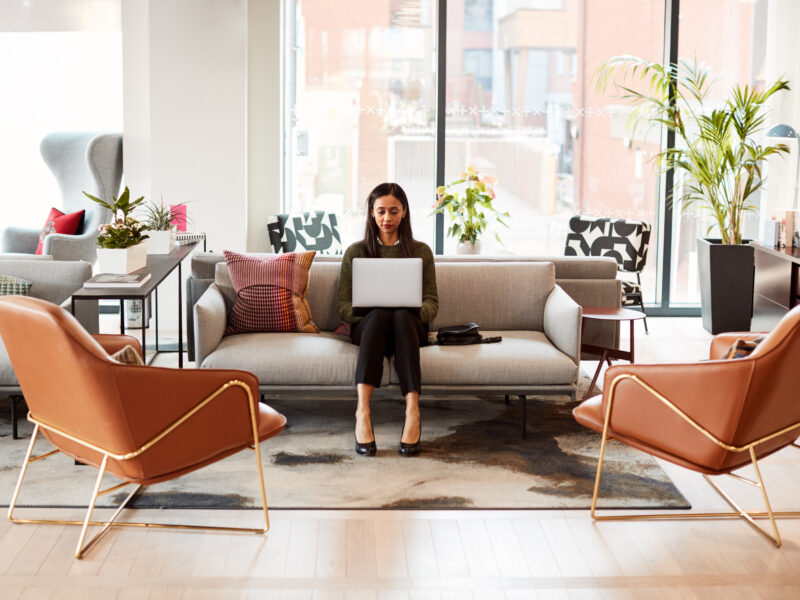 woman working with laptop on couch