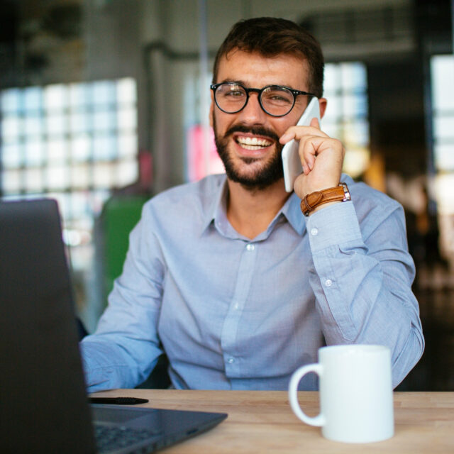 man talking on phone doing work