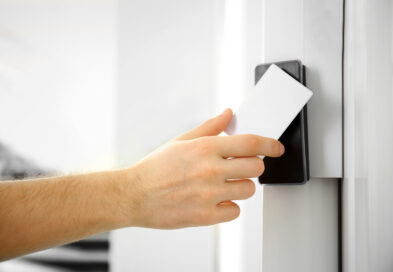 A worker scanning their keycard to enter a building, which uses a card access system.