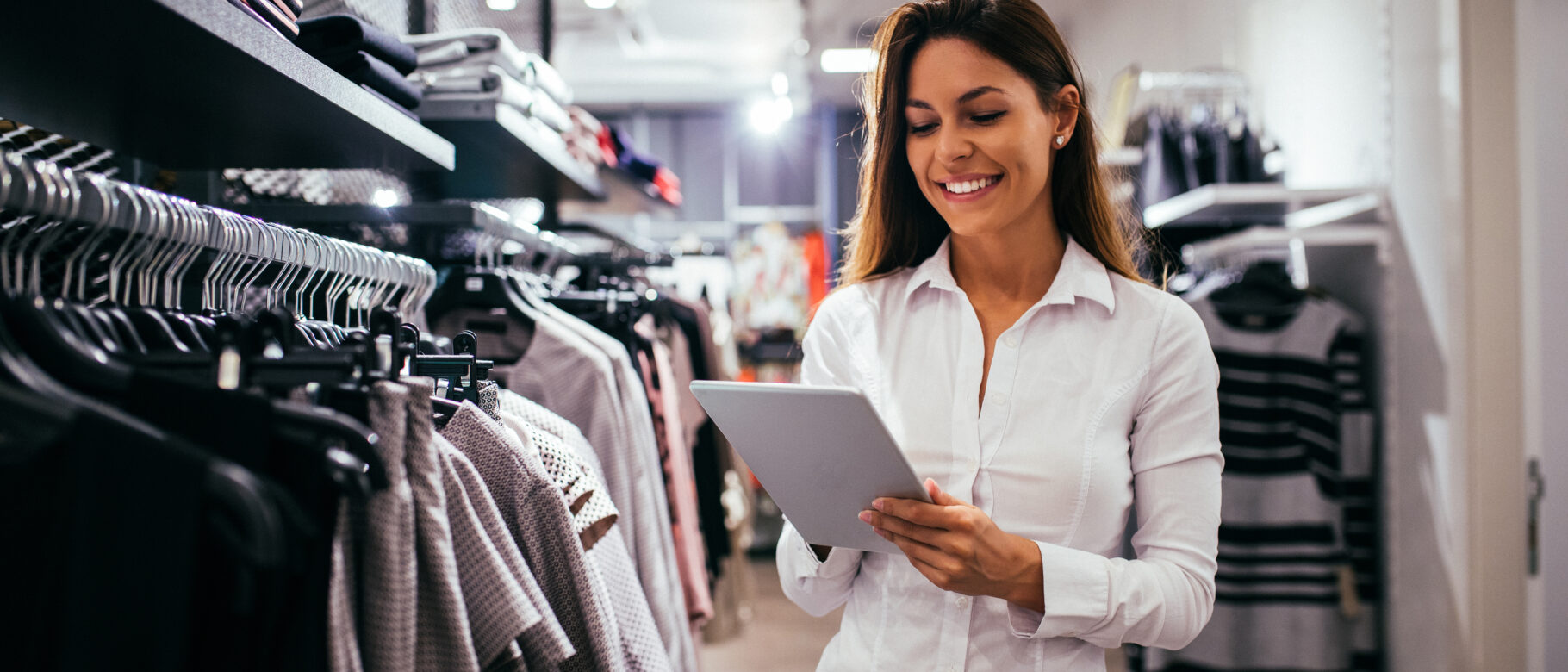 woman at retail location, looking at ipad