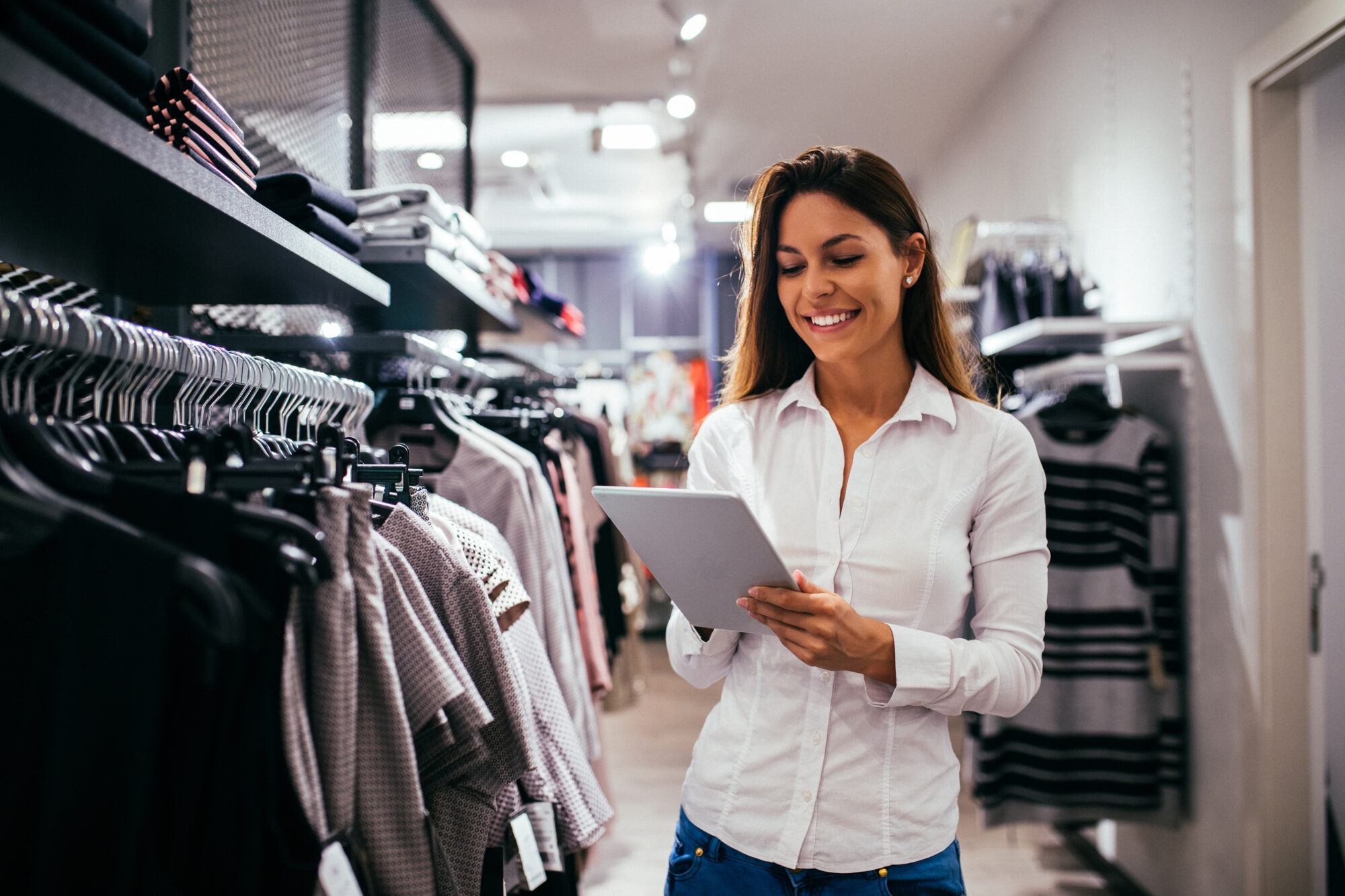 woman at retail location, looking at ipad