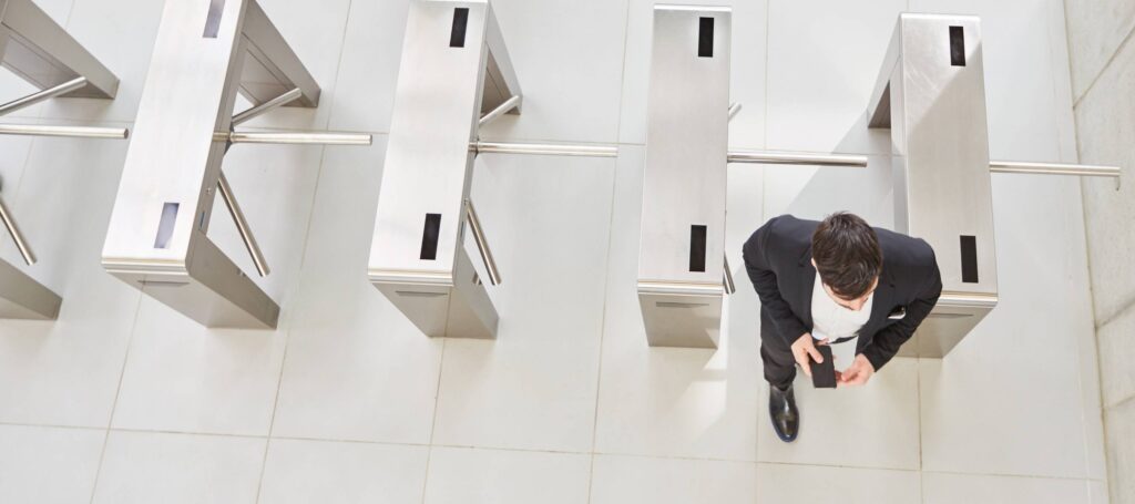 man using access control and walking through gate