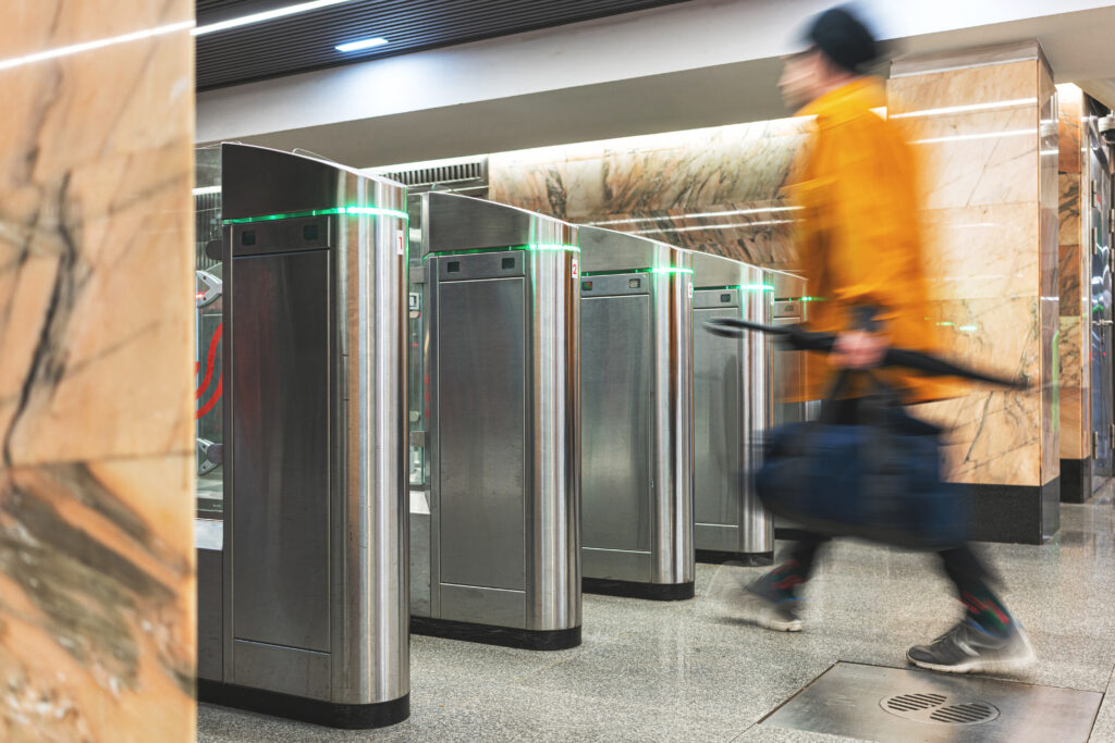 person walking through turnstile. Person using access control