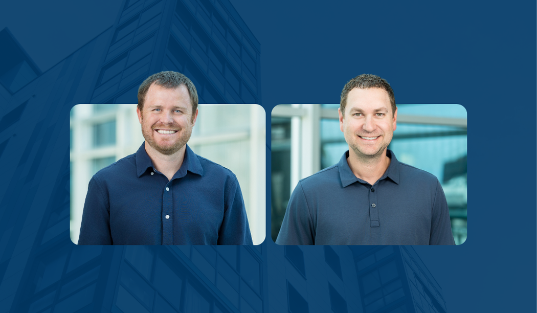 Two men in navy shirts stand smiling in professional headshots, each framed separately against a blurred background with a blue overlay featuring the faint outline of a modern building, highlighting an Executive Fireside Chat.
