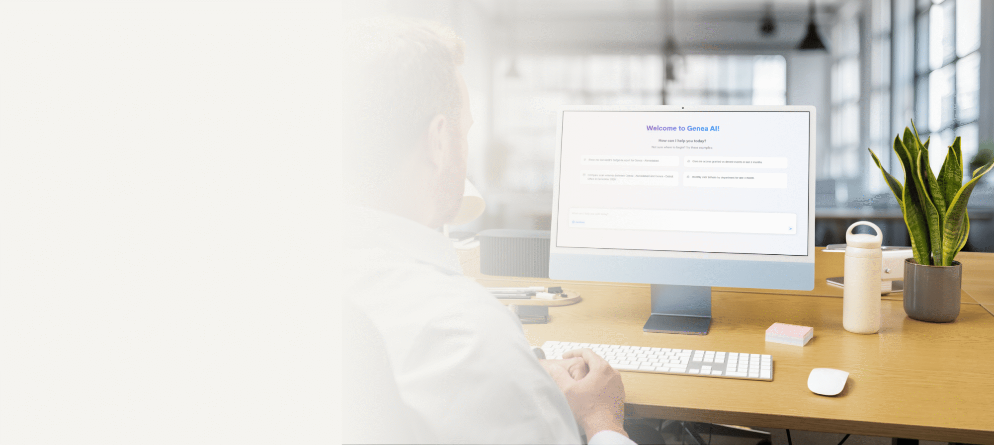 A person sits at a desk in a modern office, using a desktop computer. The screen displays a webpage titled Welcome to Genea AI. The desk holds a plant, water bottle, and office supplies, while the left side fades to a light background.